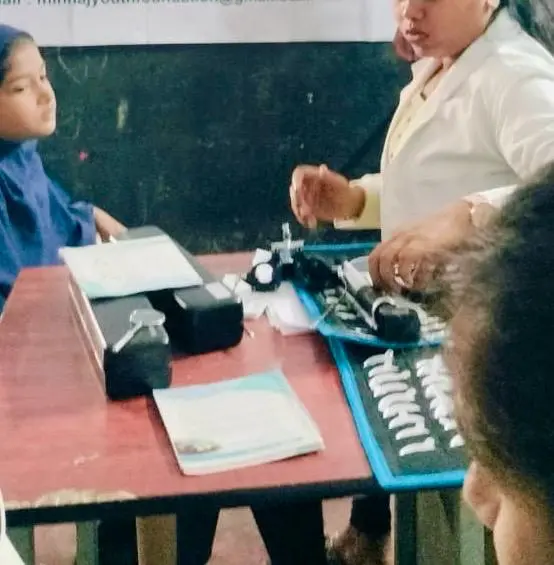A child undergoing an eye examination during a school-based vision screening camp.