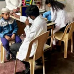 Doctors volunteering their time for free eye and general health check-ups at a local school outreach camp.